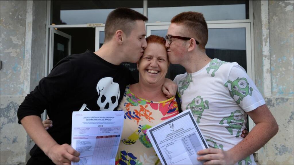 Suzanne Doyle happy for her twin sons, Nathan (left) and Jordan, who received their Leaving Cert results from St John’s College, Ballyfermot. Photograph: Brenda Fitzsimons