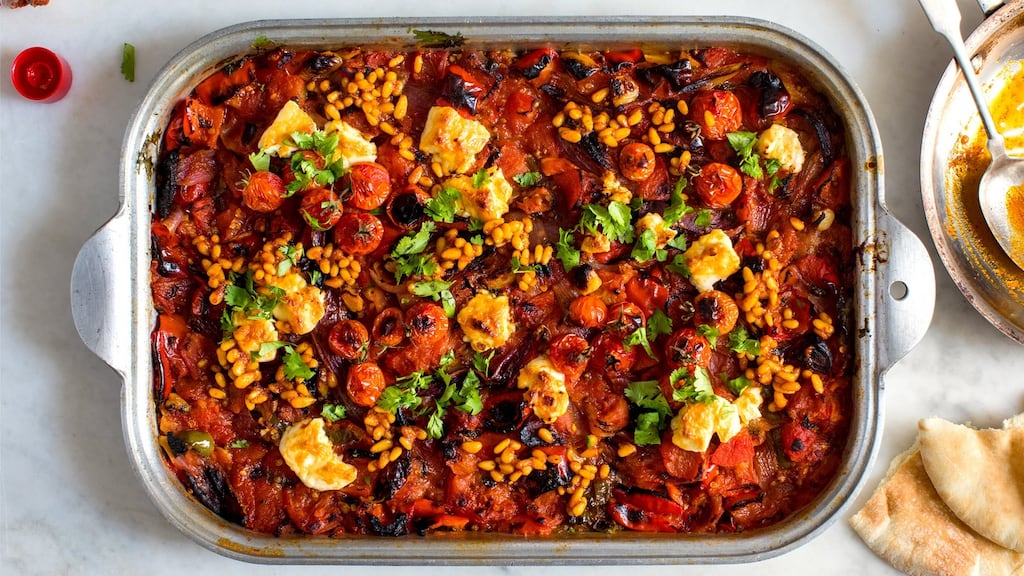 Charred tomatoes with feta and harissa pine nuts, a dish inspired by North African salads. Photographs: Andrew Scrivani/The New York Times