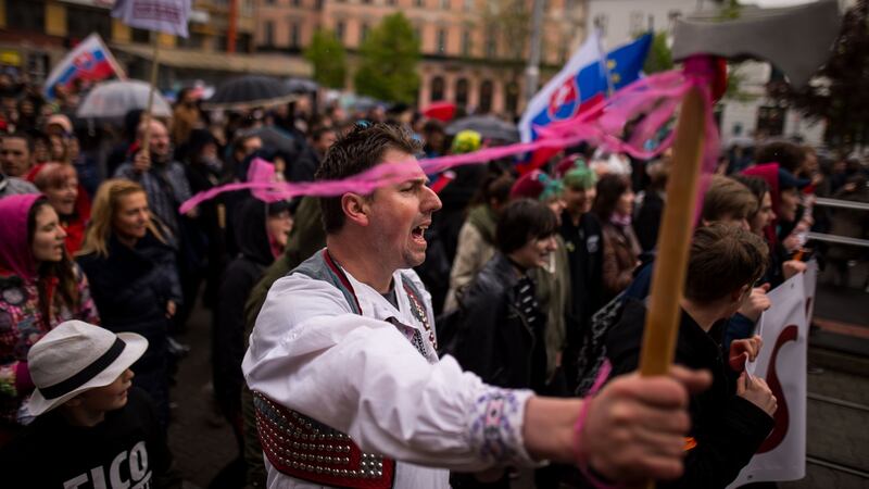 A demonstrator dressed in a traditional costume taking part in an anti-corruption rally in Bratislava, Slovakia, on Tuesday. Photograph:  Vladimir Simicek/AFP/Getty Images