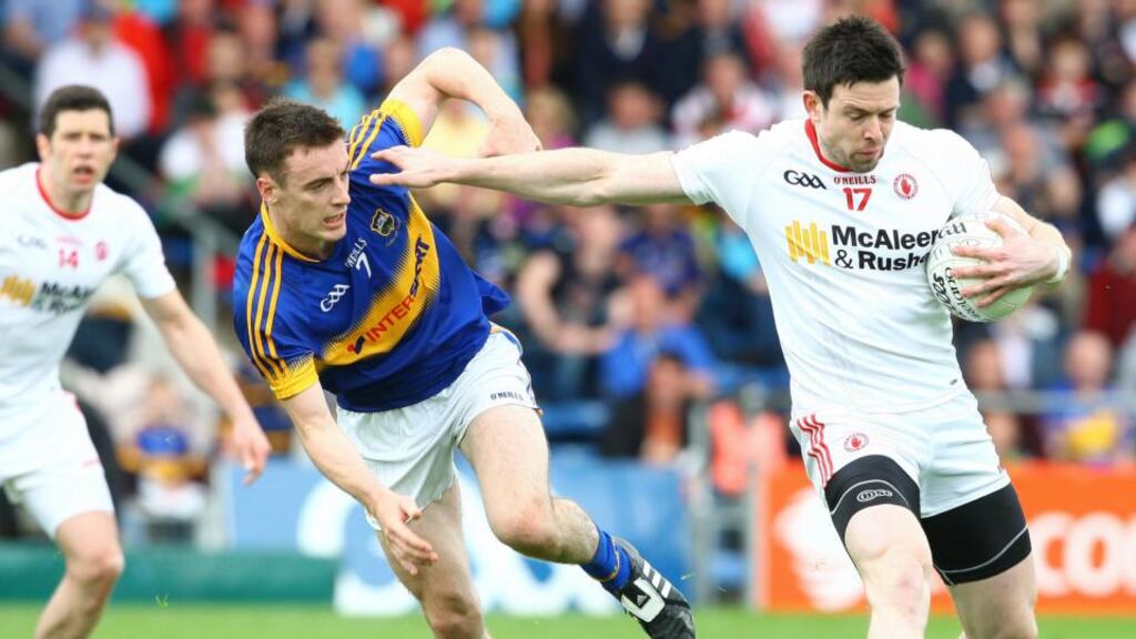 Tyrone’s Conor Clarke holds off the challenge of Tipperary’s Alan Campbell during the qualifier at Semple Stadium on Saturday. Photograph: Ken Sutton/Inpho