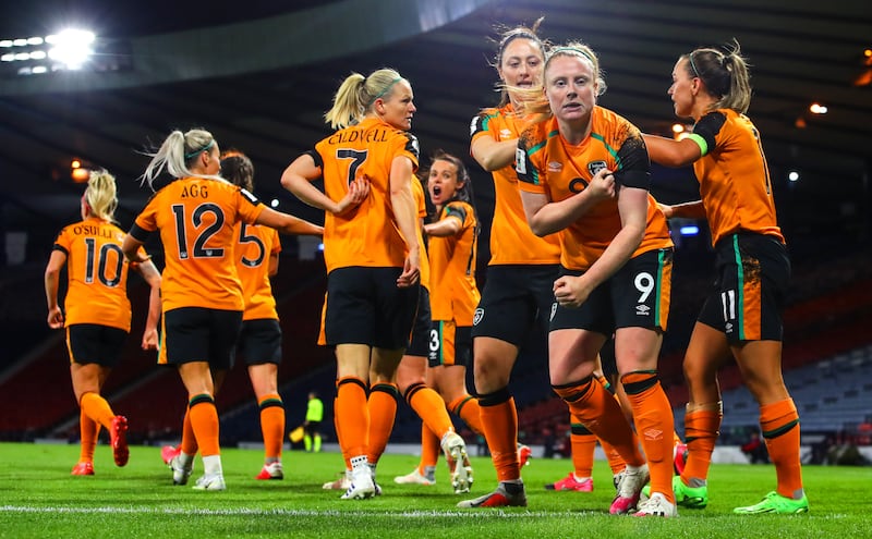 Amber Barrett celebrates her goal against Scotland in Ireland's World Cup playoff win by kissing her black armband worn in memory of those affected by the tragedy in Creeslough. Photograph: Ryan Byrne/Inpho