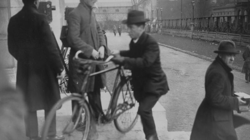 Cathal Brugha arrives by bicycle at a Dáil Éireann meeting in Dublin University in December 1921. Photograph: Hulton Archive/Getty Images