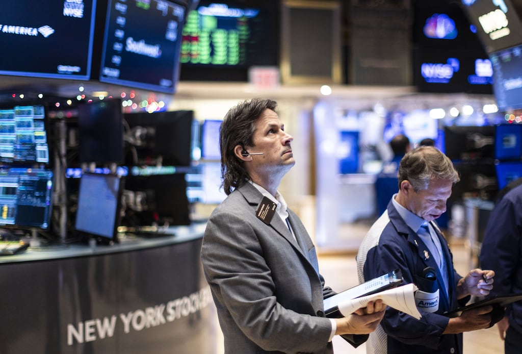 Traders work on the floor of the New York Stock Exchange. Global stocks rose on Tuesday as EU investors were encouraged by data showing a slowdown in inflation and indications from one central banker that interest rates will fall next year. Photograph: EPA