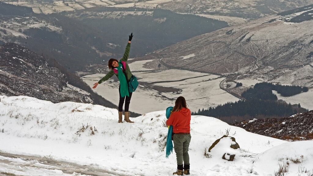 Tourists enjoying the latest snowfall at Sally Gap, Co Wicklow, yesterday.