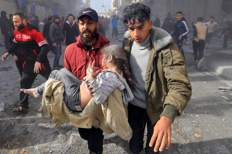A man carries an injured child following an Israeli strike on Rafah in the southern Gaza Strip on Monday. Photograph: Mahmud Hams/Getty Images