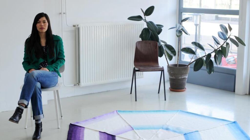 Jennifer Tee with one of her handwoven rugs