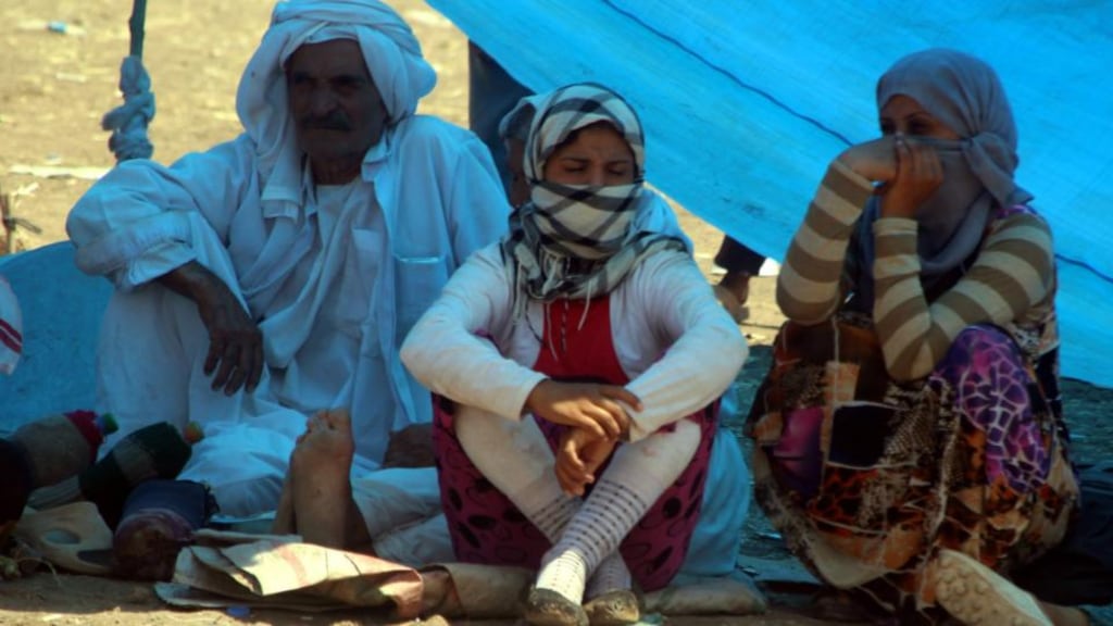 Members of the Yazidi religious minority  at the Syria-Iraq border in Fishkhabour, northern Iraq. Amnesty gives examples where entire Yezidi families have been kidnapped and are being held in terrible conditions in Mosul and villages captured by the Islamic State. Photograph: EPA