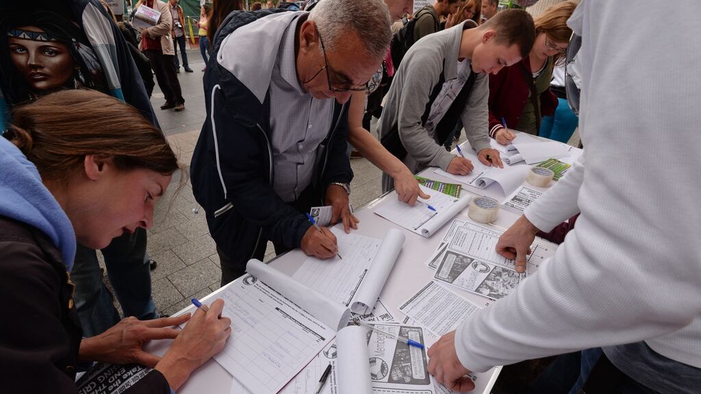 Members of the public in Dublin sign a People Before Profit petition calling on the Government to take the €13bn owed by Apple in taxes and spend it on social housing. Photograph: Alan Betson/The Irish Times