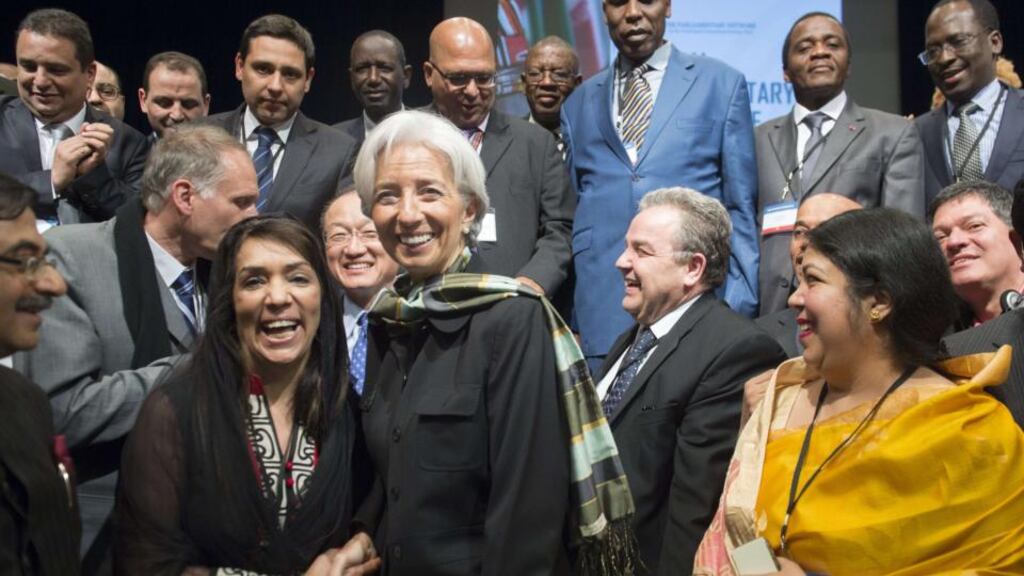 International Monetary Fund (IMF) managing director Christine Lagarde shakes hands with Shakila Luqman, a member of the Pakistani National Assembly, as she poses for photos with attendees during the 2015 Global Parliamentary Conference at the World Bank Headquarters in Washington.
