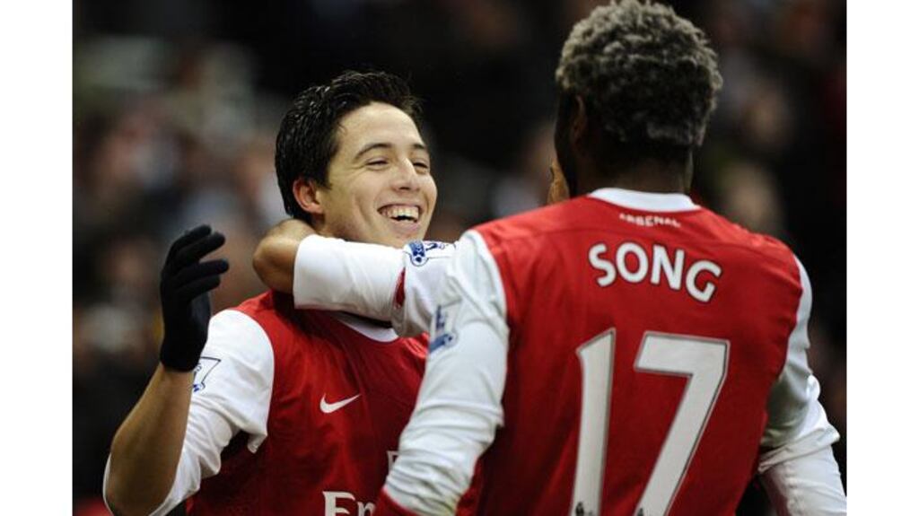 Arsenal's Samir Nasri (L) celebrates with team mates after scoring twice in the 2-1 win against Fulham at the Emirates stadium, London (Photograph: Dylan Martinez/Reuters)