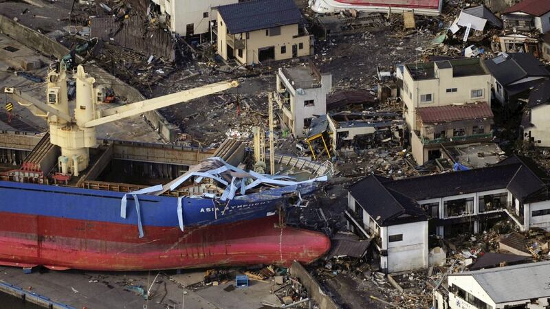 An under-construction boat sits on land next to damaged homes in the city of Kamaishi after a massive 8.9 magnitude quake and tsunami hit the region on March 11th, 2011. Photograph: Yomiuri Shimbun/AFP/Getty Images