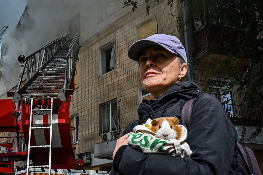 A woman is evacuated from an apartment that was hit by a missile strike in Kharkiv. Sergey Bobok/Getty Images