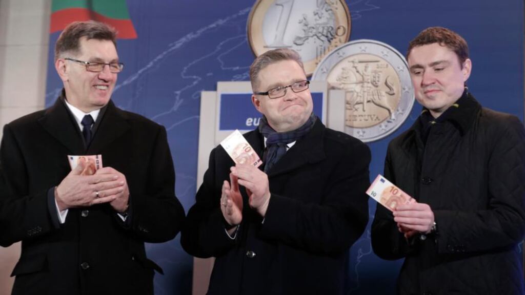 Lithuania’s prime minister Algirdas Butkevicius, central bank governor Vitas Vasiliauskas and Estonia’s prime minister Taavi Roivas celebrate Lithuania becoming the 19th member of the euro zone. Photograph: Ints Kalnins/Reuters