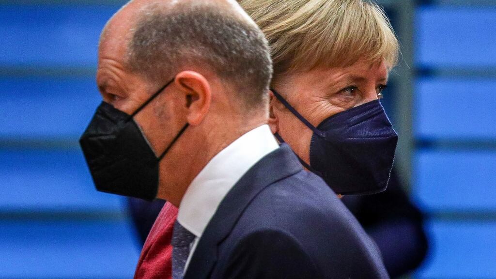 German minister of finance and Social Democratic Party candidate Olaf Scholz and German chancellor Angela Merkel pass each other by at the weekly government cabinet meeting in Berlin on Wednesday. Photograph: Omer Messinger/Getty Images