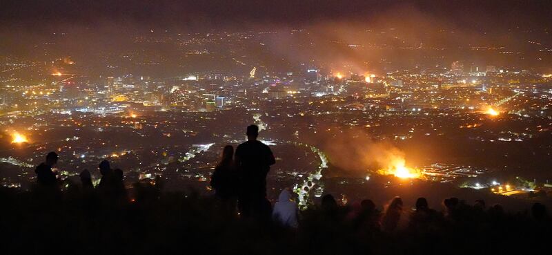 People look out from Cavehill across Belfast city of loyalist bonfires burning during Twelfth commemorations marking the anniversary of the Protestant King William's victory over the Catholic King James at the Battle of the Boyne in 1690. Photograph: Niall Carson/PA