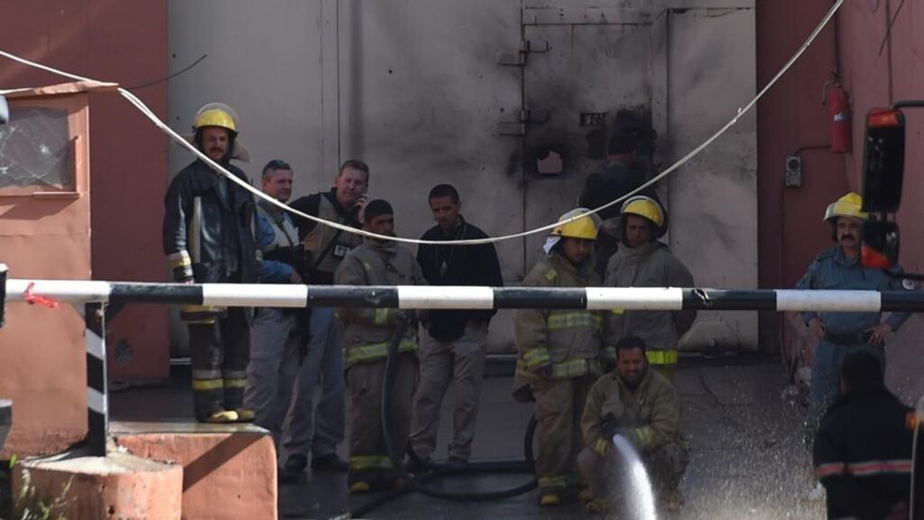 Afghan firefighters spray water in front of the gates of the Heetal Hotel in Kabul the morning after gunfire and explosions rang out in a diplomatic quarter of the city overnight. Security forces waged an all-night battle with Taliban militants who tried to storm a guesthouse owned by a prominent political family. The standoff ended at daybreak with all four attackers killed, a government minister said, reporting no civilian or military casualties. Photograph: Farshad Usyan/AFP/Getty Images