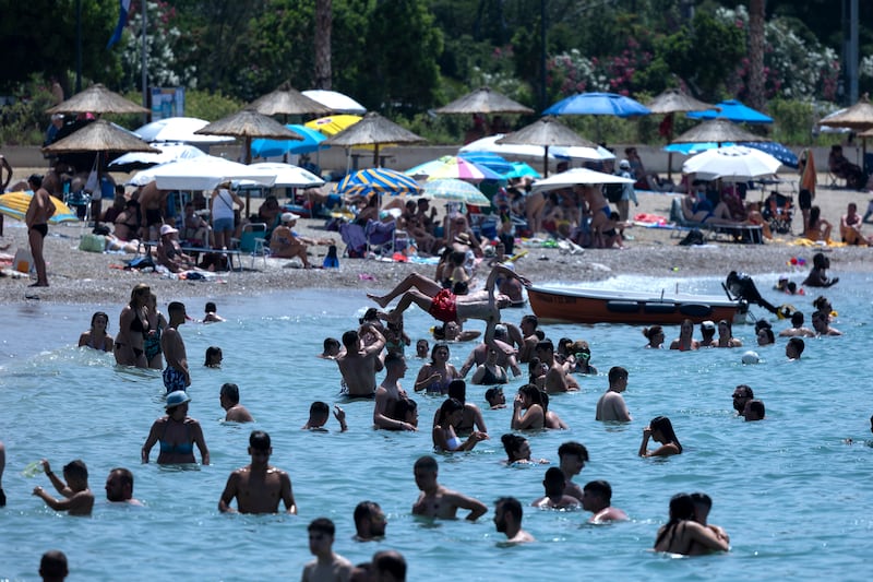 Swimmers enjoy the sea at the Glyfada suburb of Athens. Photograph: Yorgos Karahalis/AP