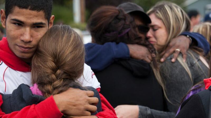 Students and family members embrace after leaving Marysville-Pilchuck High School in the aftermath of a shooting on the high school’s campus yesterday. Photograph: David Ryder/Getty Images