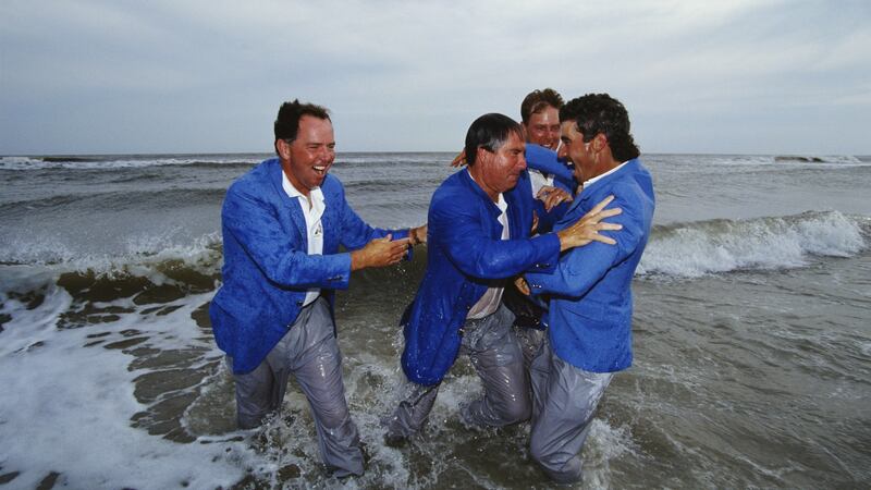 Mark O’Meara and Payne Stewart look on as team captain Dave Stockton pushes Corey Pavin into the water after the USA won the 1991 Ryder Cup. Photo: Simon Bruty/Allsport