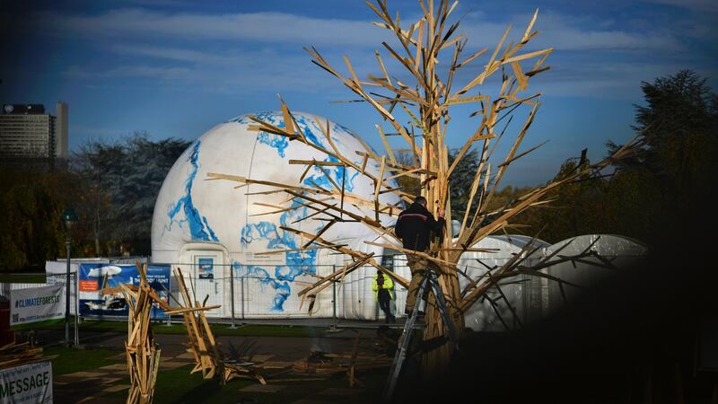 A craftsman adds parts to a sculpture, Climate Tree, during the UN Climate Change Conference COP23 in Bonn, Germany, today. Photograph: Philipp Guelland/EPA