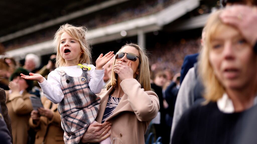 Race-goers Laura Biddlecombe and daughter Sophie watch the Supreme Novices’ Hurdle on the opening day of the Cheltenham Festival. Photograph: Steven Paston/PA Wire for the Jockey Club