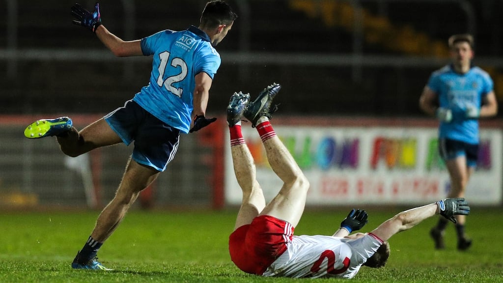 Dublin’s Niall Scully trips up a Tyrone player, earning himself a black card, at Healy Park, Omagh on Saturday. Photograph: Tommy Dickson/Inpho