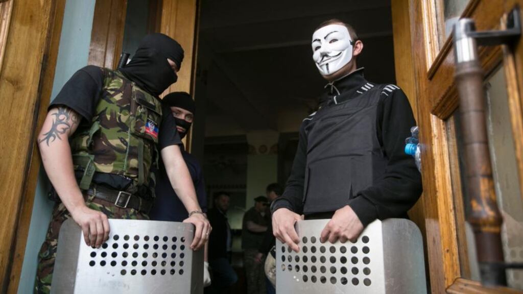 Pro-Russian activists block the entrance to a television station in Donetsk, eastern Ukraine today. Photograph: Baz Ratner/Reuters.