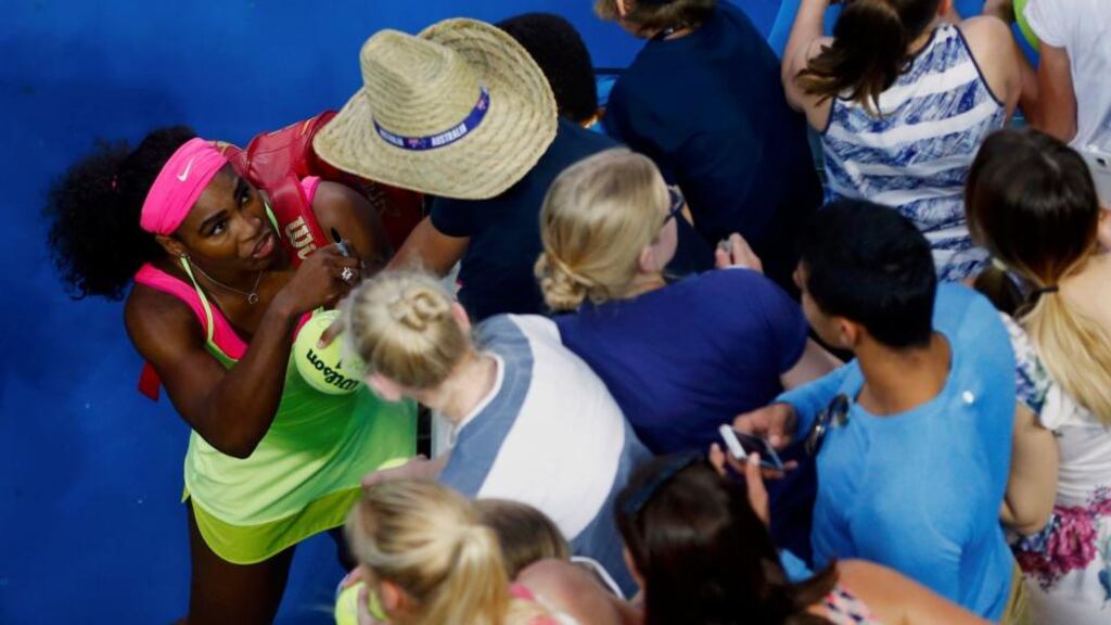 Serena Williams  signs autographs as she leaves the court after defeating Belgium’s Alison van Uytvanck in their first-round match at the Australian Open in Melbourne. Photograph: Carlos Barria/Reuters