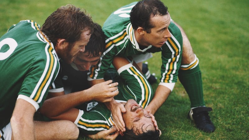 Mickey Walsh (centre, on his back) celebrates after scoring the winning goal against the USSR in a 1986 World Cup qualifier with Tony Grealish (left), Michael Robinson (centre) and Liam Brady (right). Photo: David Cannon/Allsport/Getty Images
