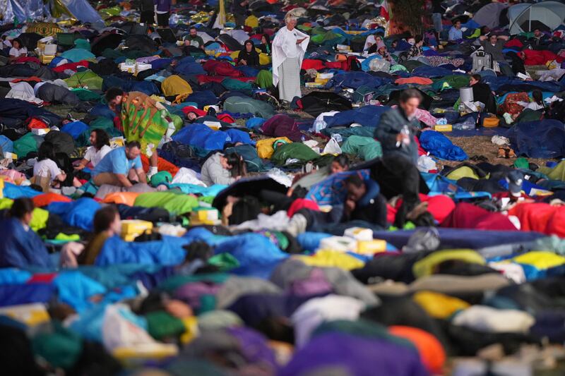 Young people wake up after spending the night at the Tor Vergata field in Rome as part of the event. Photograph: Andrew Medichini/AP