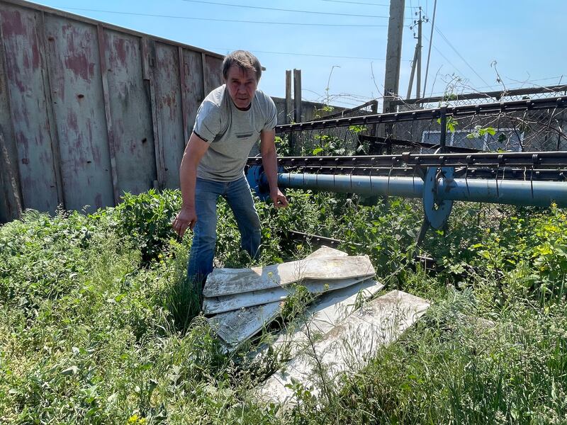 Farmer Mykola Zlobin in Mala Rohan village, outside Kharkiv in eastern Ukraine, with parts of Russian attack drones shot down by air defence systems. Photograph: Daniel McLaughlin