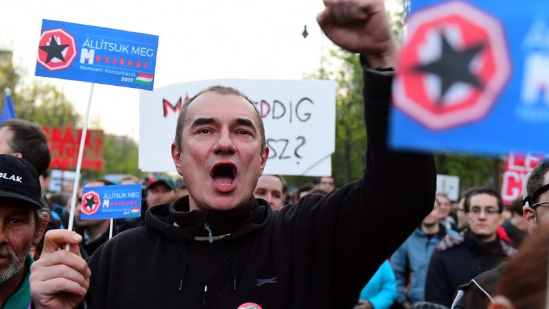 A protester  against Hungary’s prime minister Viktor Orban, whom critics say is overly influenced by Russia. Photograph: Attila Kisbenedek/AFP/Getty Images