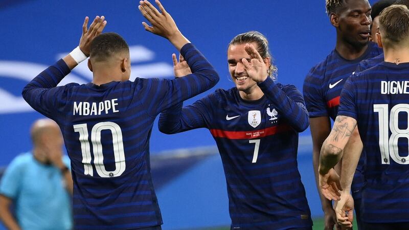 Kylian Mbappe celebrates with Antoine Griezmann after the Barcelona forward scores France’s second against Wales. Photograph: Franck Fife/Getty/AFP