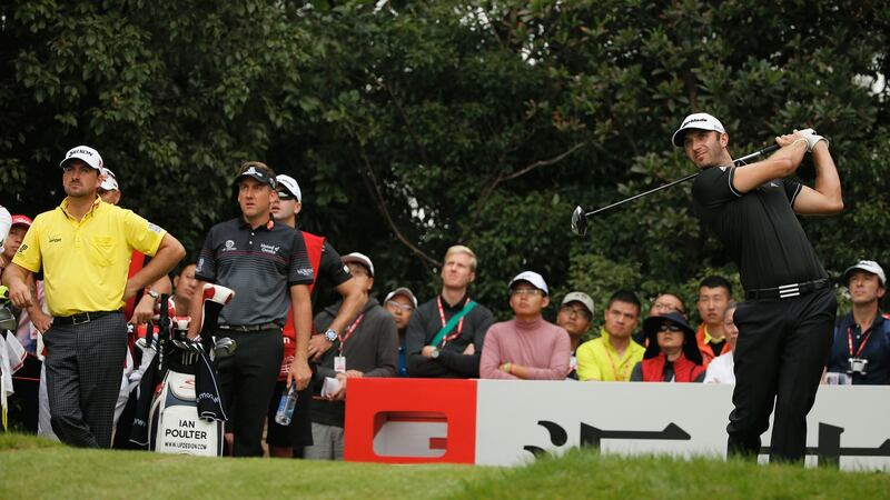 Graeme McDowell and Ian Poulter look on as Dustin Johnson plays his tee shot on the second hole during the final round of the 2013 WGC-HSBC Champions at the Sheshan International Golf Club  in Shanghai. Photograph:  Scott Halleran/Getty Images