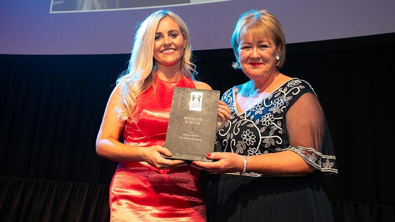 Brenda Dooley, Awards Head Judge, presents the HR Rising Star of the Year award to Marcie Green, The Taxback Group.