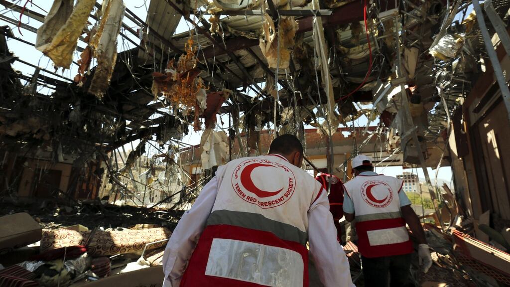 Members of Yemen Red Crescent Society look for remains of airstrikes victims inside the destroyed funeral hall a day after Saudi-led airstrikes targeted it, in Sana’a, Yemen. Photograph: EPA/Yahya Arhab
