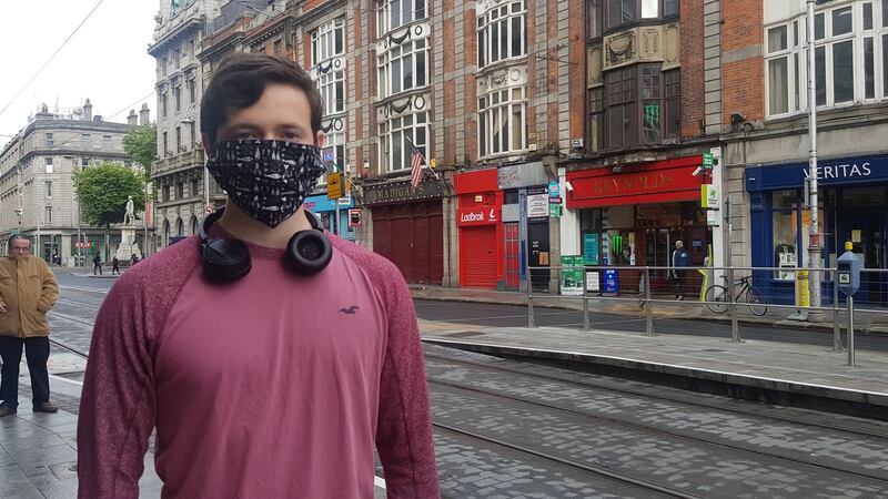 Rory Curran wearing a facemask after alighting the Luas in Dublin on Monday. Photograph: Shauna Bowers