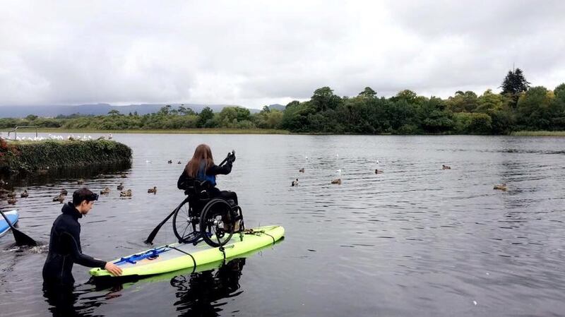 Geraldine Lavelle paddleboarding in her chair: she uses a manual, rather that a power wheelchair, in order to maintain her fitness levels