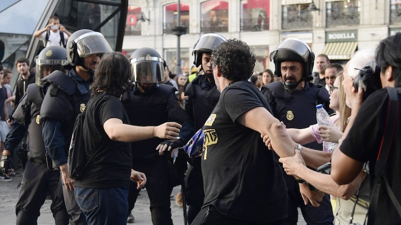 Protesters confront Spanish National police officers during a demonstration at Puerta del Sol square on Sunday. Phogoraph: Javier Soriano/AFP/Getty Images