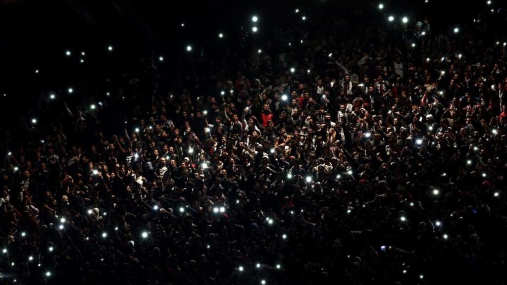 The crowd in the Attaturk Stadium in Istanbul lights up after the floodlights failed during Tottenham’s Europa League group C match against Besiktas. Photograph: Sedat Suna /EPA