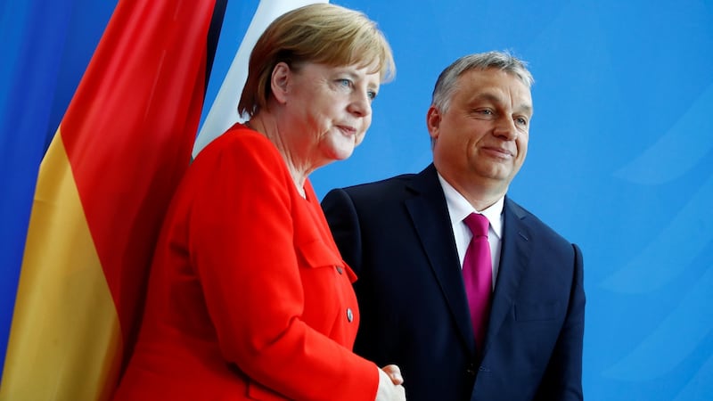 German chancellor Angela Merkel and Hungarian prime minister Viktor Orban shake hands after addressing the media in Berlin, Germany. Photograph: Reuters/Axel Schmidt