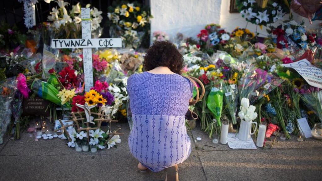 A woman mourns at the memorial site outside the Emanuel African Methodist Episcopal (AME) Church in Charleston, South Carolina. Photograph: John Taggart, EPA