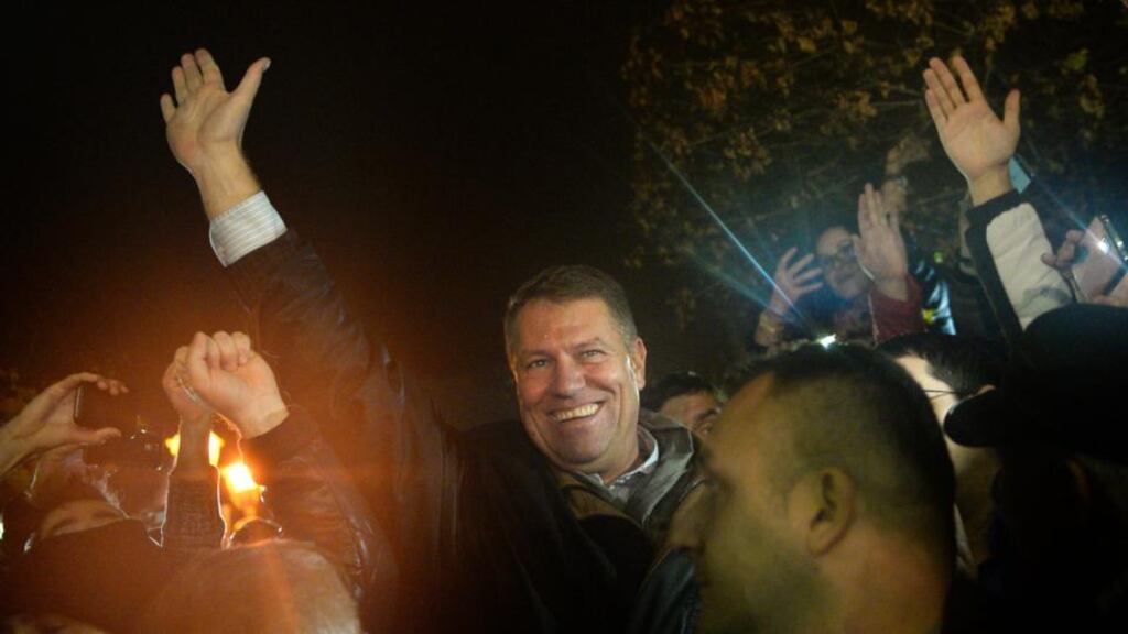 Klaus Iohannis salutes the crowds in central Bucharest Romania yesterday. He defied expectations to win Romania’s presidential election yesterday, inflicting a shock defeat on prime minister Victor Ponta. Photograph: Raed Krishan/EPA