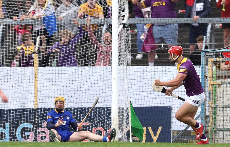 Lee Chin beats Eibhear Quilligan to score Wexford's third goal of the game against Clare during the All-Ireland quarter-final at FBD Semple Stadium. Photograph: Tom Maher/Inpho