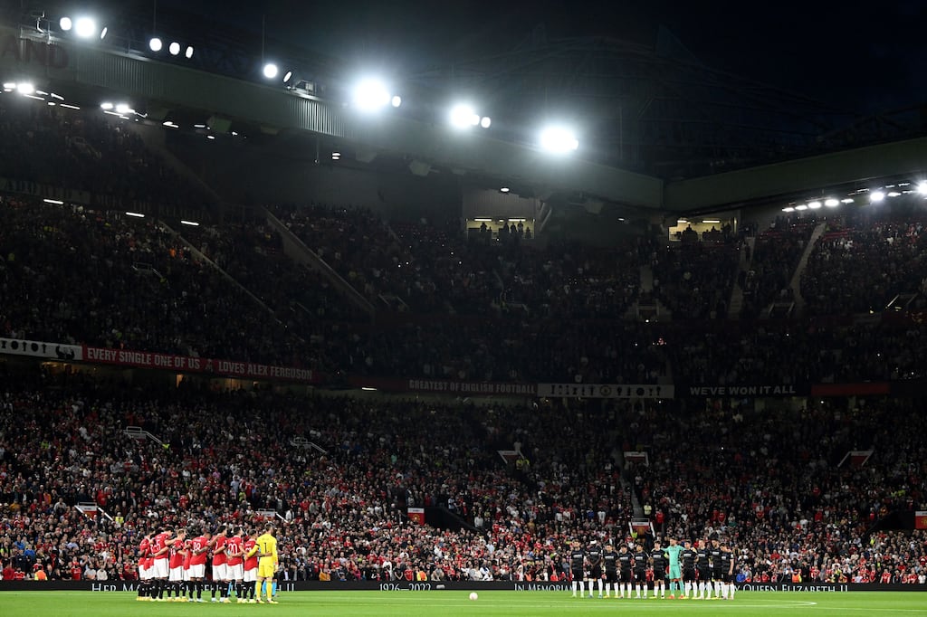 The teams pose for a moment's silence following the death of Queen Elizabeth II, ahead of the UEFA Europa League Group E football match between Manchester United and Real Sociedad. Photograph: Oli Scarff/AFP via Getty Images
