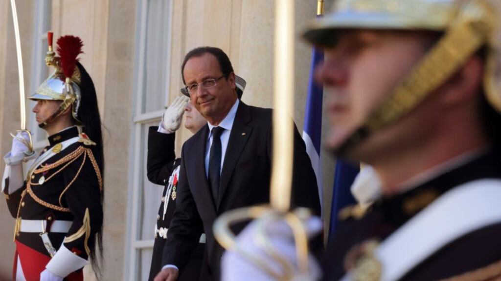 France’s president Francois Hollande (C) stands on the steps of the Elysee Palace in Paris on Tuesday. Mr Hollande had assumed airstrikes against Syria would be under way before today’s parliamentary debate on the issue. Photograph: Philippe Wojazer/Reuters