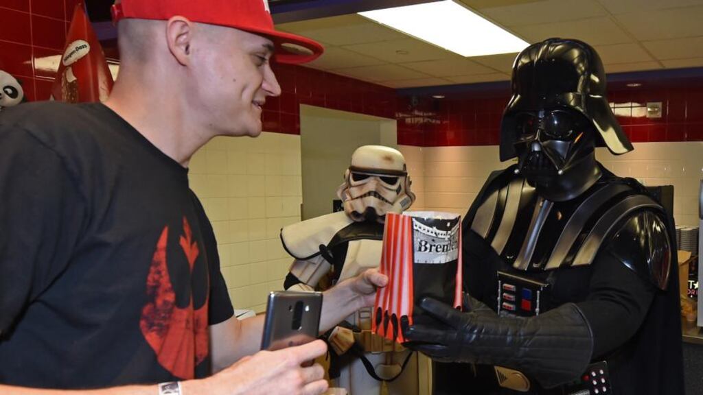 Star Wars: Darth Vader serves popcorn at a US cinema. Photograph: Ethan Miller/Getty
