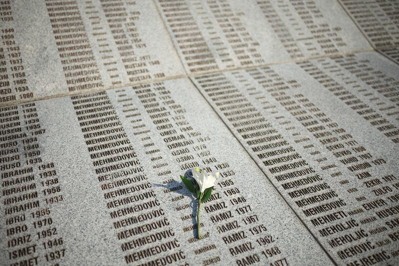 A flower is seen on a monument with the names of those killed in the Srebrenica genocide. Photograph: Armin Durgut/AP