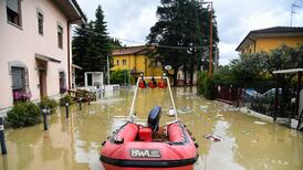 Crews work to rescue people trapped by floods in northern Italy