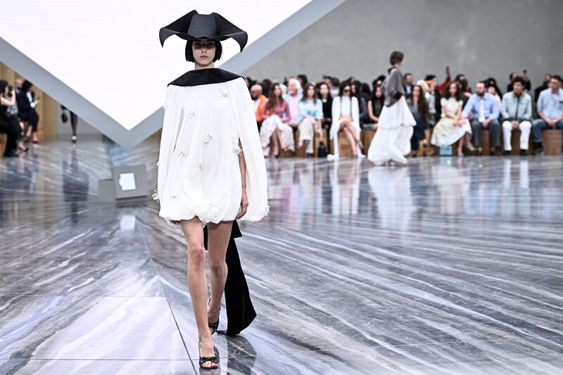 The hats were playful takes on the tricorn, giving the outfits a certain insouciant swagger. Photograph: by JULIEN DE ROSA/AFP via Getty Images